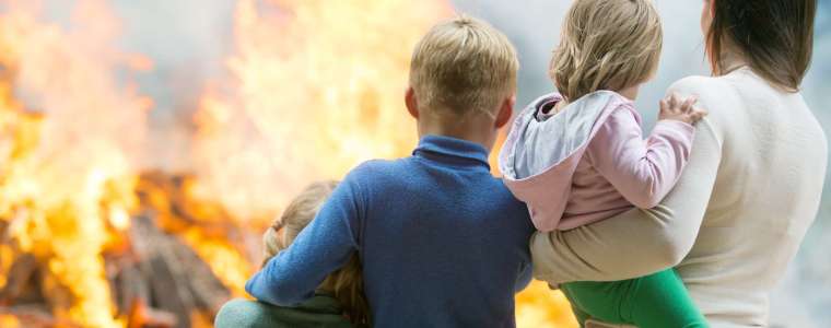 Family watching home burn